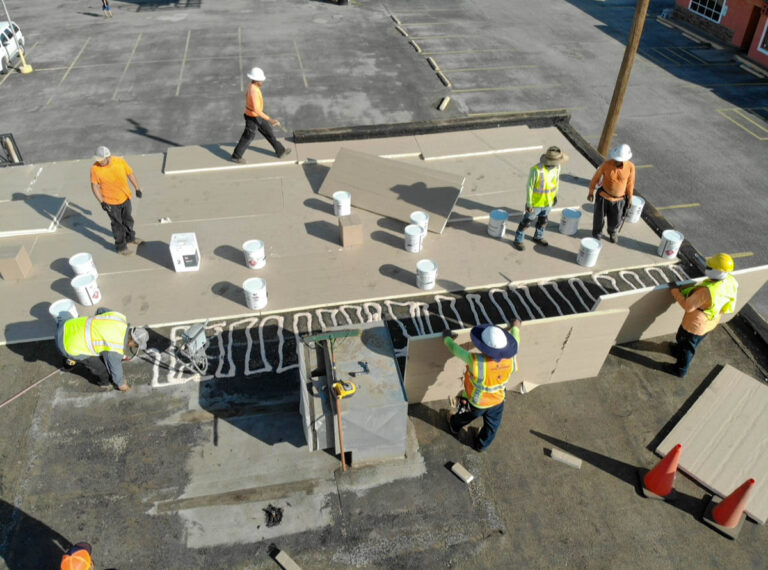 Roofing crew installing a commercial flat roof
