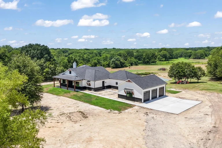 Aerial view of the farmhouse and detached three-bay garage