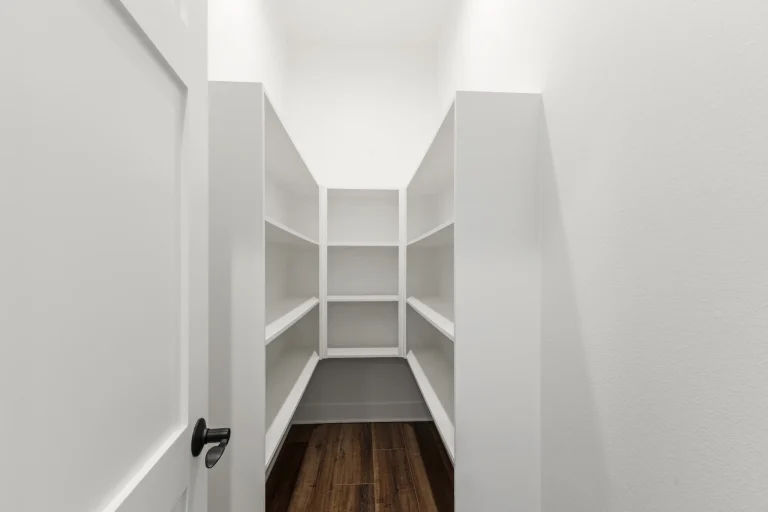 Walk-in pantry with white shelving