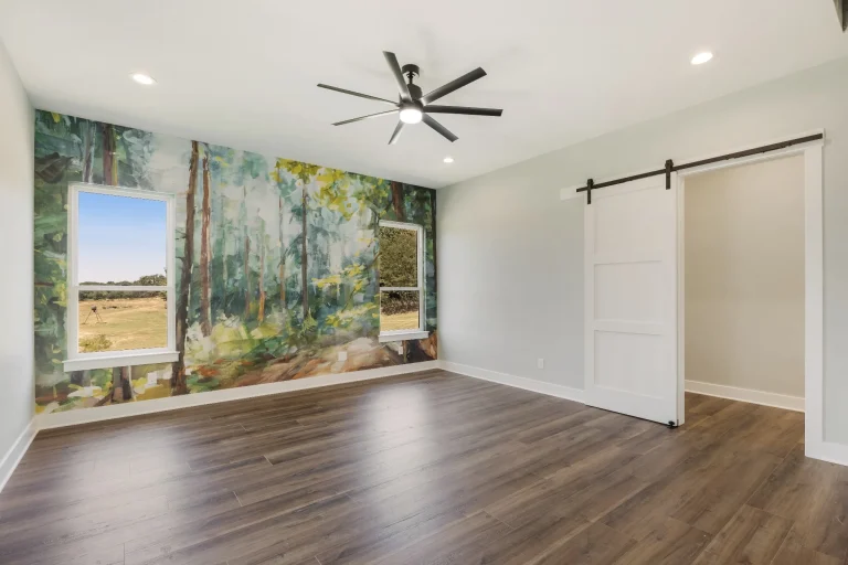Room with landscape mural and sliding barn door