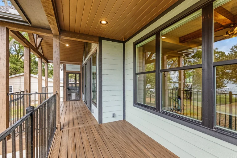 Screened porch with wood ceiling and black railing