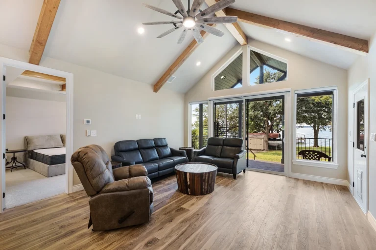 Great room with beamed vaulted ceiling and lake-facing windows