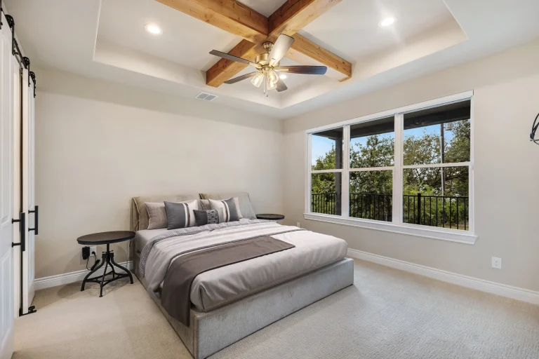 Primary bedroom with beamed tray ceiling
