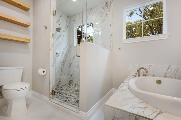 Primary bath with soaking tub and frameless glass shower